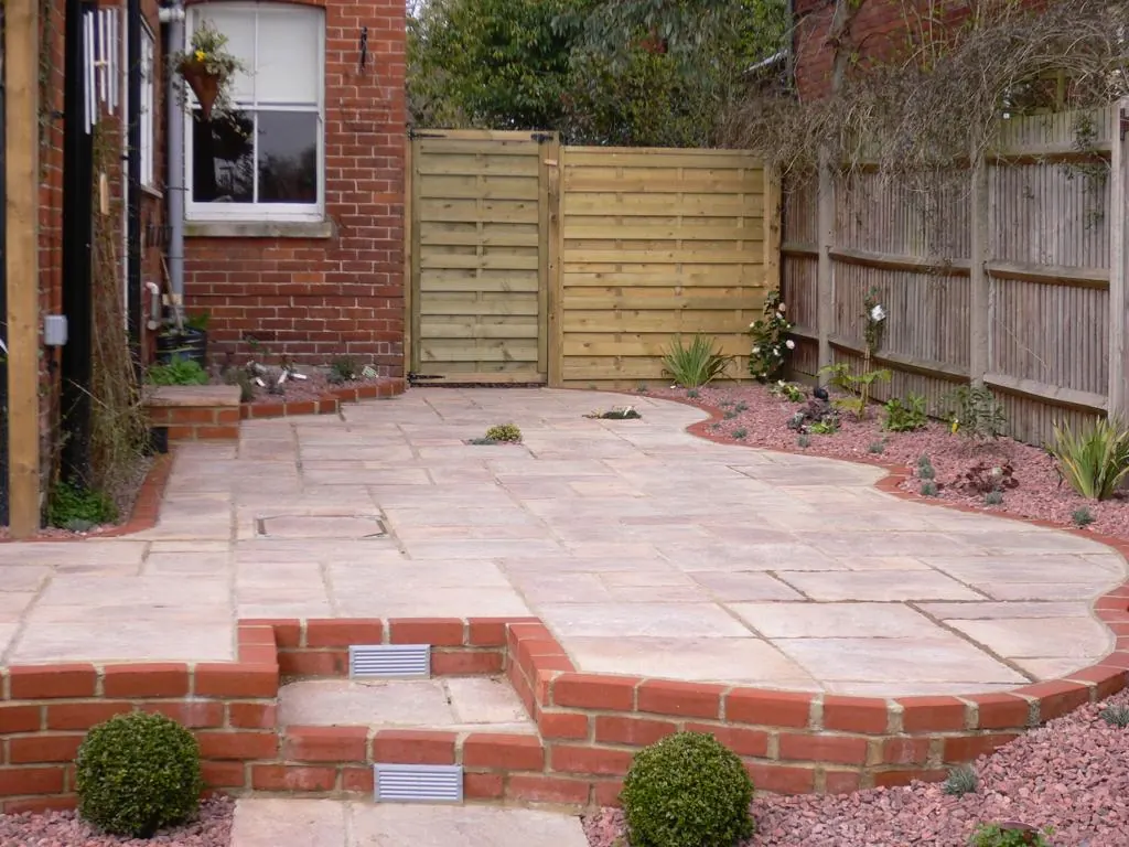 Indian sandstone patio with brick steps - Reading