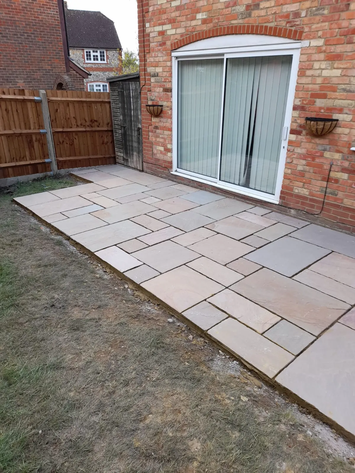 Sandstone patio behind family home - Reading